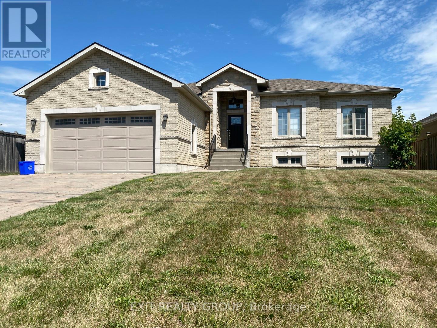 A house with a garage and a driveway is for sale.
