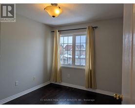 A room with a window and curtains.
