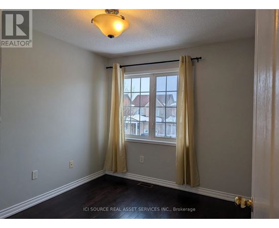 A room with a window and curtains.