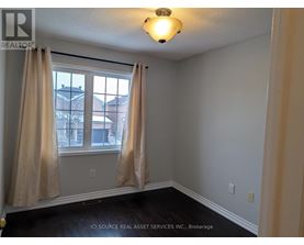 A room with a window and curtains.