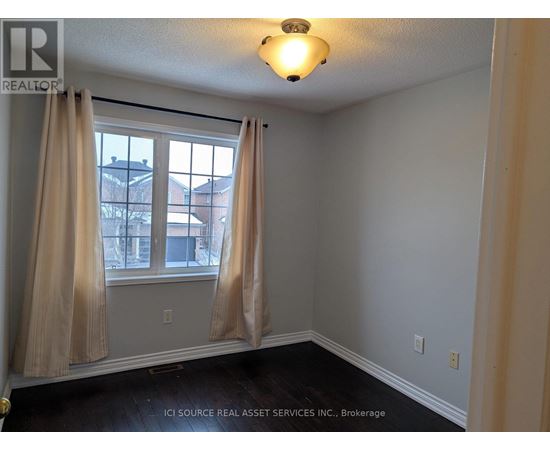 A room with a window and curtains.