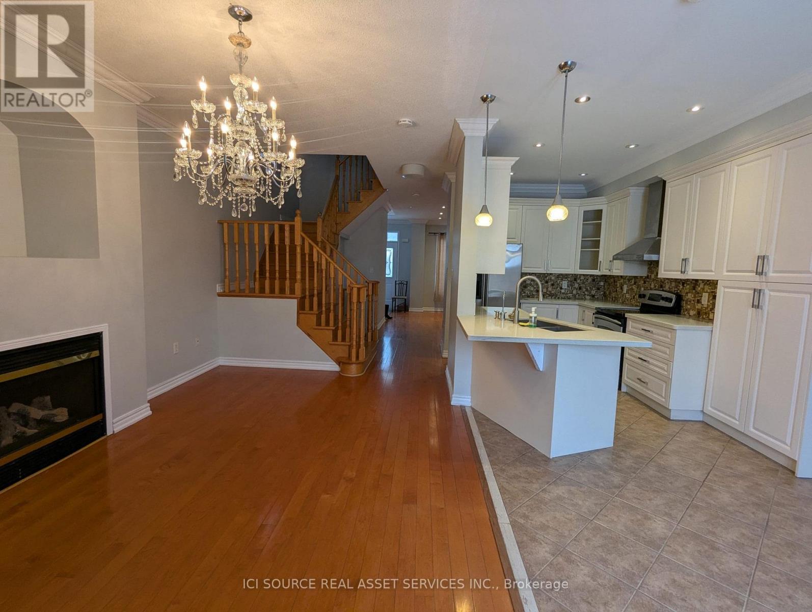 A large open space with a staircase and a fireplace.