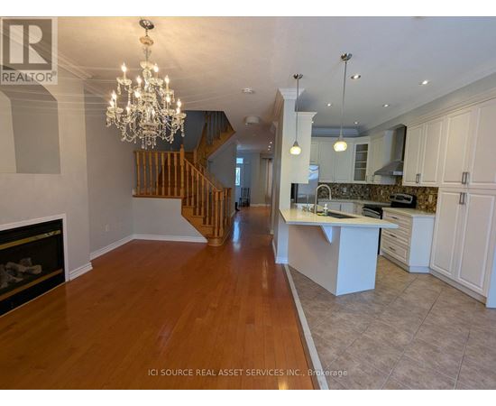 A large open space with a staircase and a fireplace.