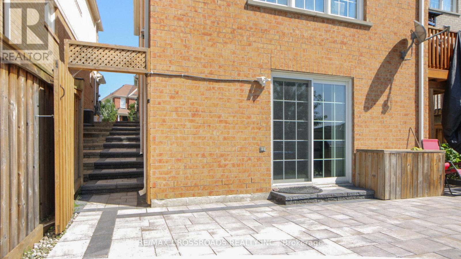 A brick house with a glass door and a wooden fence.