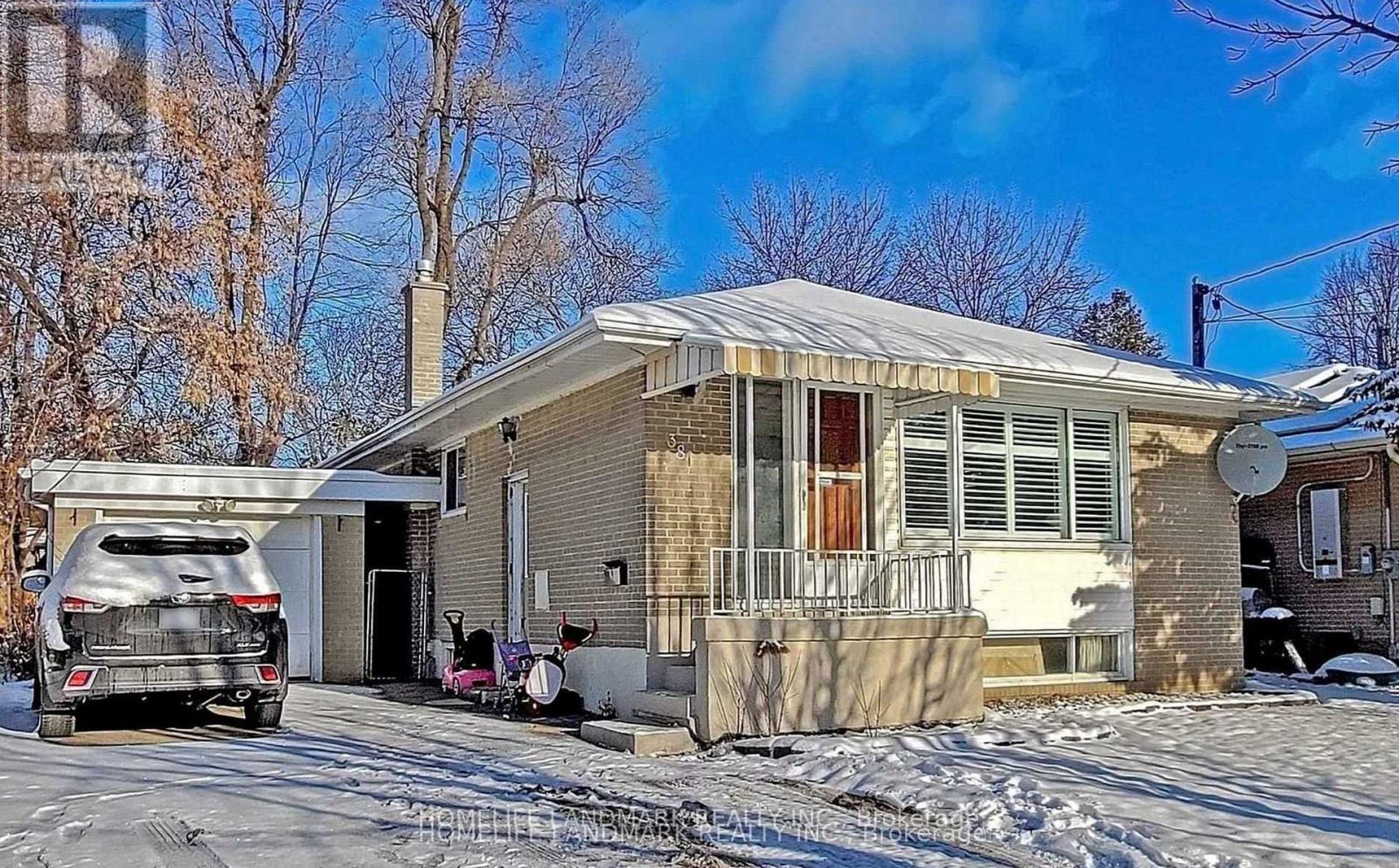 A house with a car parked in front of it.
