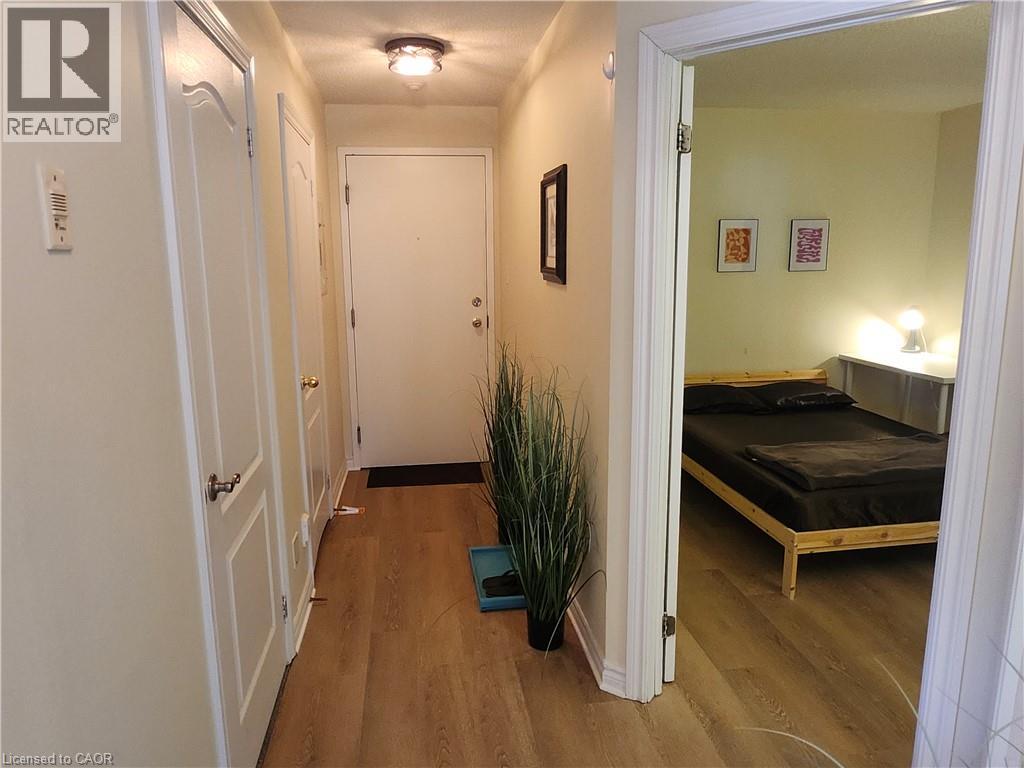 A hallway with a bedroom at the end.