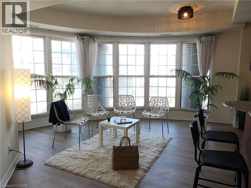 A living room with a table and chairs.