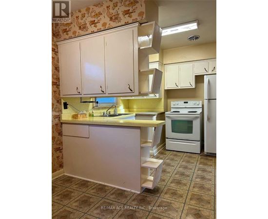 A kitchen with white cabinets and a yellow counter.