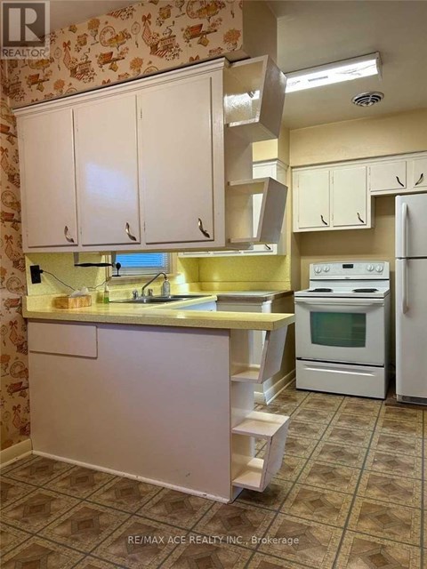 A kitchen with white cabinets and a yellow counter.