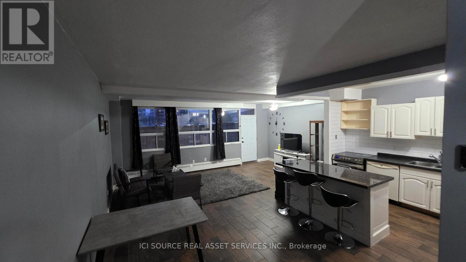 A modern kitchen with a dining table and chairs.