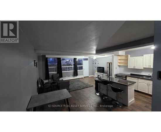A modern kitchen with a dining table and chairs.