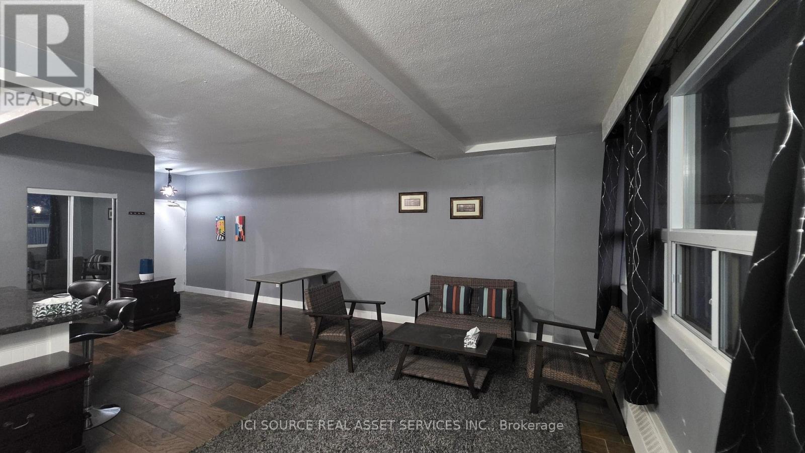 A living room with a couch, chair, and a coffee table.
