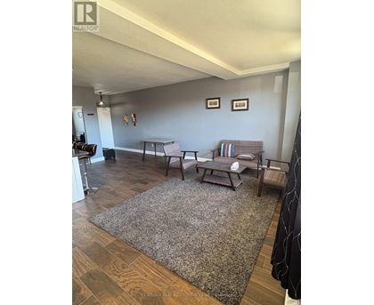 A living room with a couch, chair, and a coffee table.