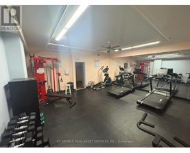 A gym with treadmills, weights, and exercise equipment.