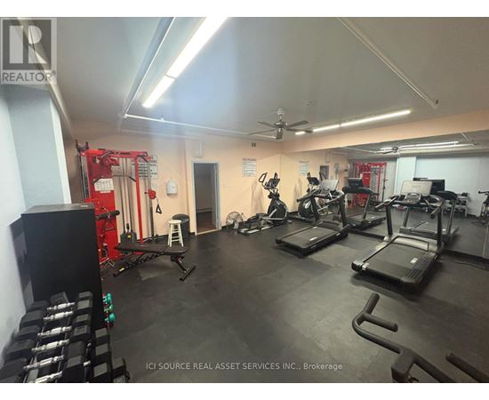 A gym with treadmills, weights, and exercise equipment.