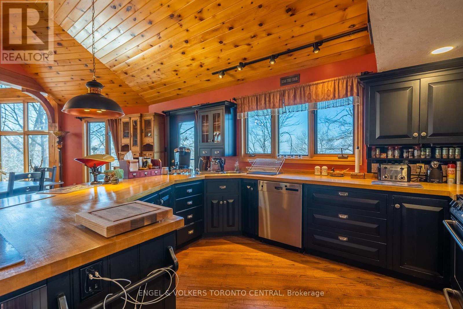 A kitchen with wooden cabinets and a large island.