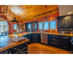 A kitchen with wooden cabinets and a large island.