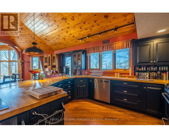 A kitchen with wooden cabinets and a large island.