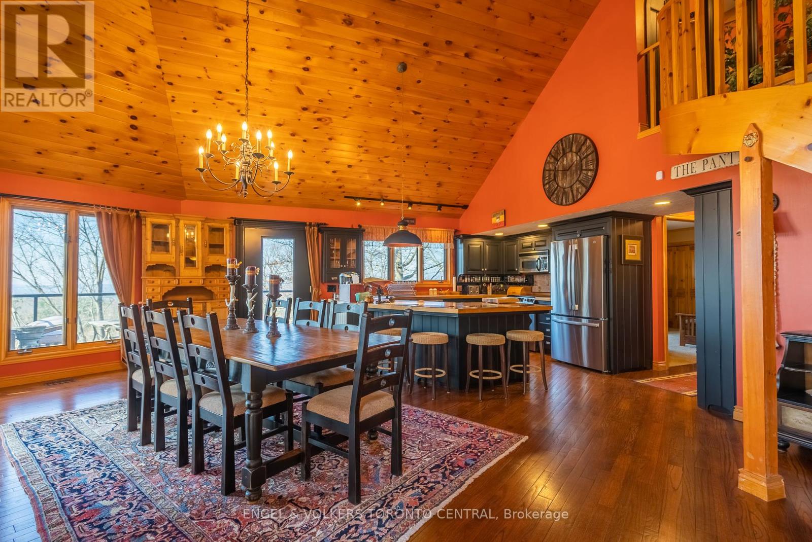A large dining room with a wooden table and chairs.
