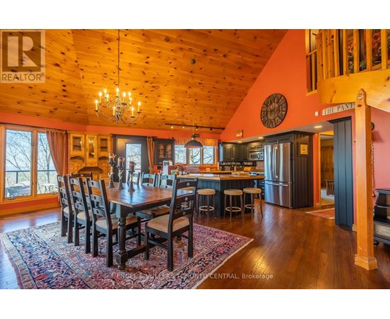 A large dining room with a wooden table and chairs.