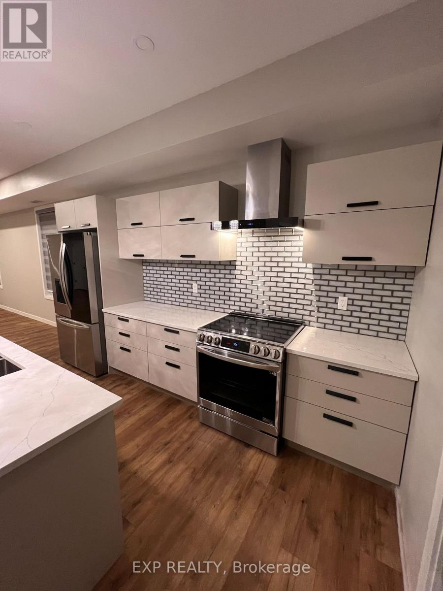 A kitchen with a stove top oven and a refrigerator.