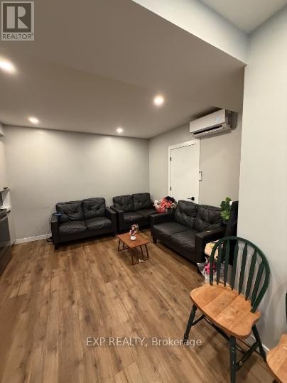 A living room with a black couch set and a wooden coffee table.