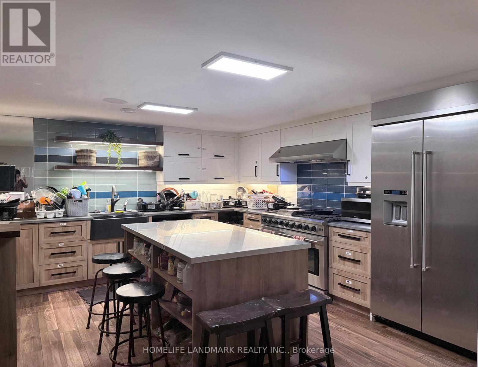 A modern kitchen with stainless steel appliances and wooden cabinets.