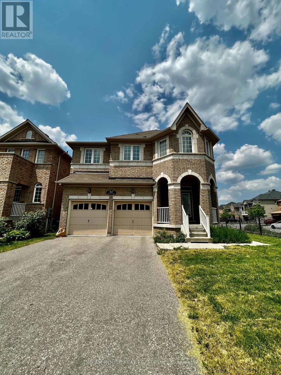 A large house with a driveway in front of it.