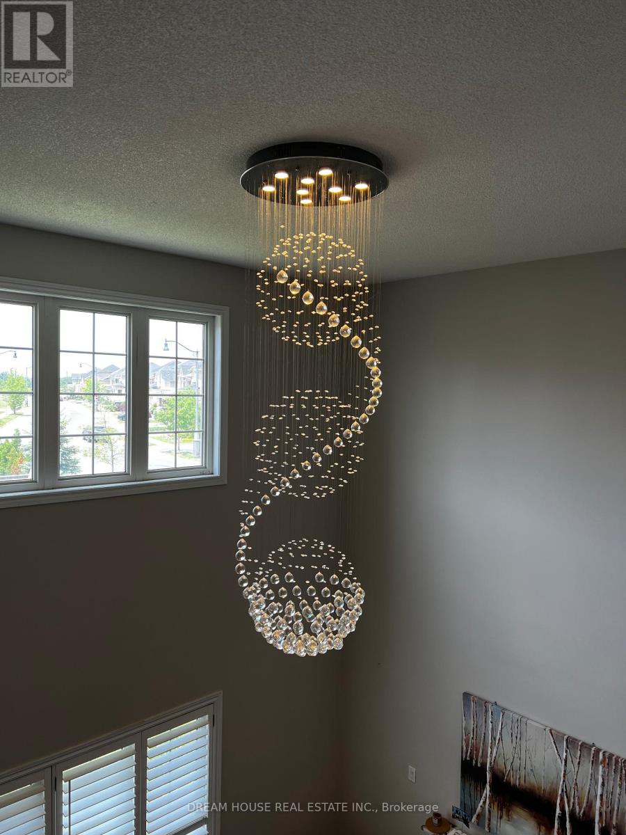 A chandelier with a spiral design hangs from the ceiling in a room.