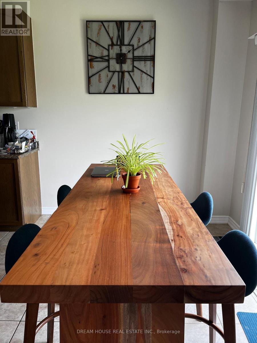 A wooden table with a plant on it and chairs around it.