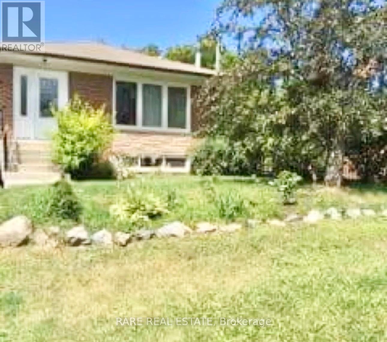 A house with a lawn in front of it.