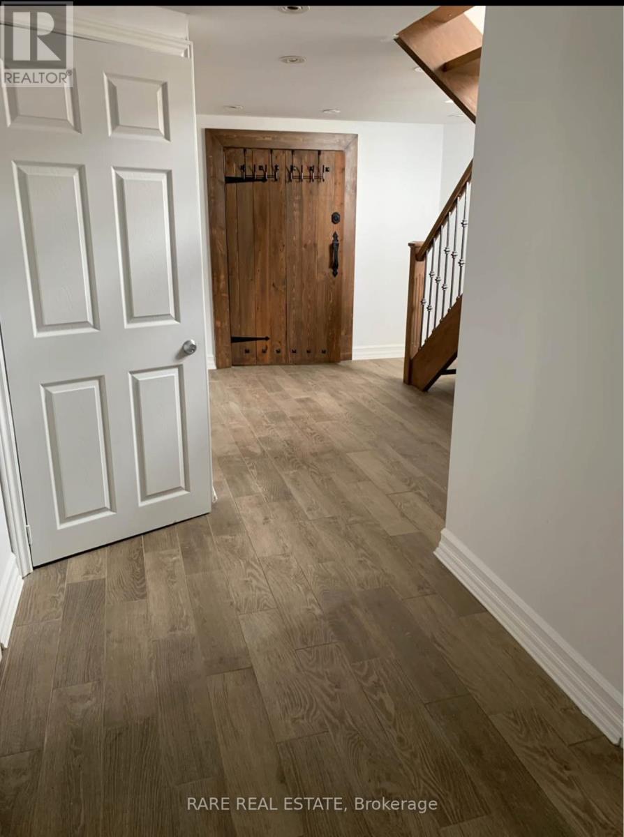 A hallway with a white door and a wooden door at the end.
