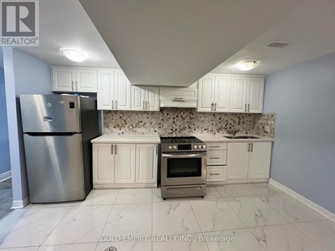 A kitchen with white cabinets and a granite countertop.