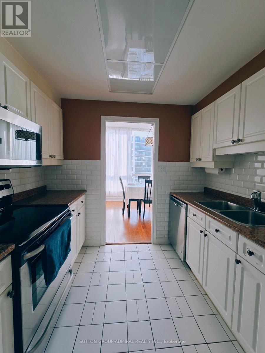 A kitchen with white cabinets and a black stove top oven.