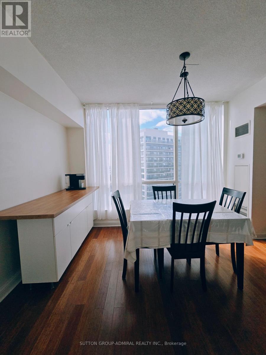 A dining room with a table and chairs.