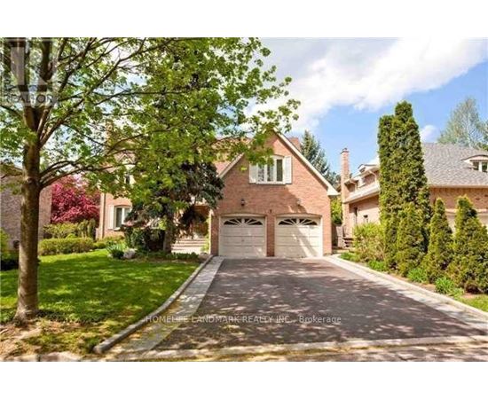 A house with a driveway and garage doors.