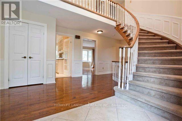 A spacious home interior with a staircase leading to the upper floor.