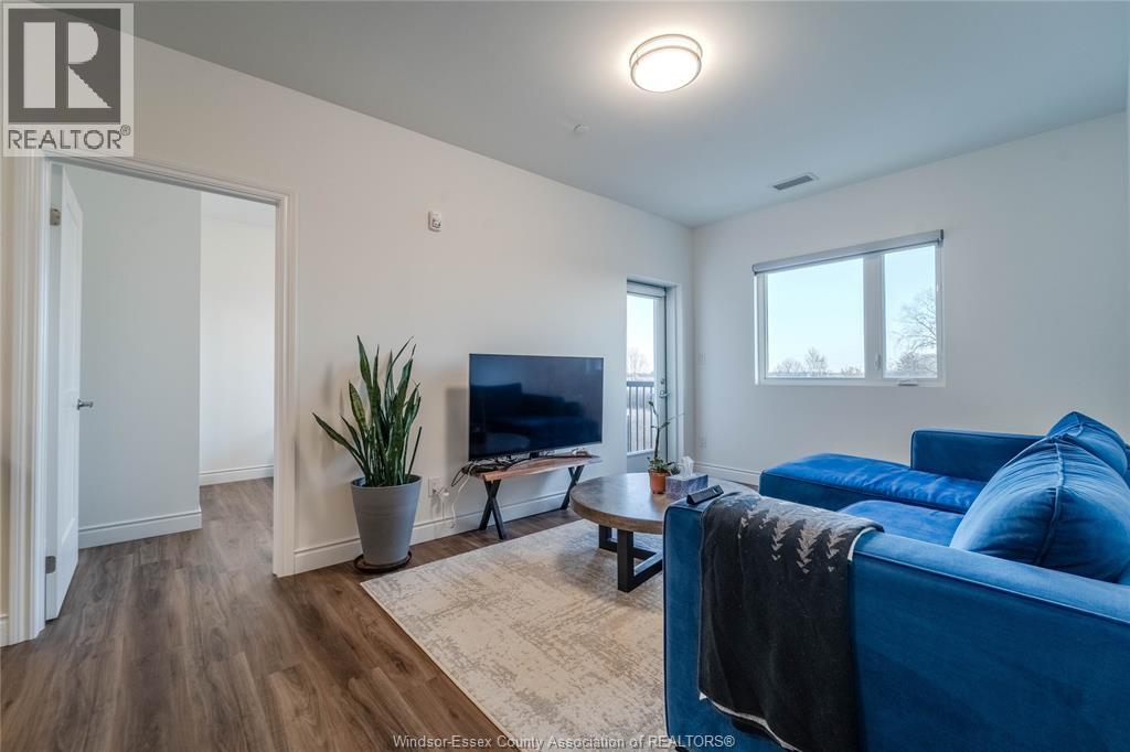 A living room with a blue couch and a television.