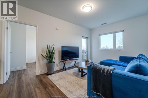 A living room with a blue couch and a television.