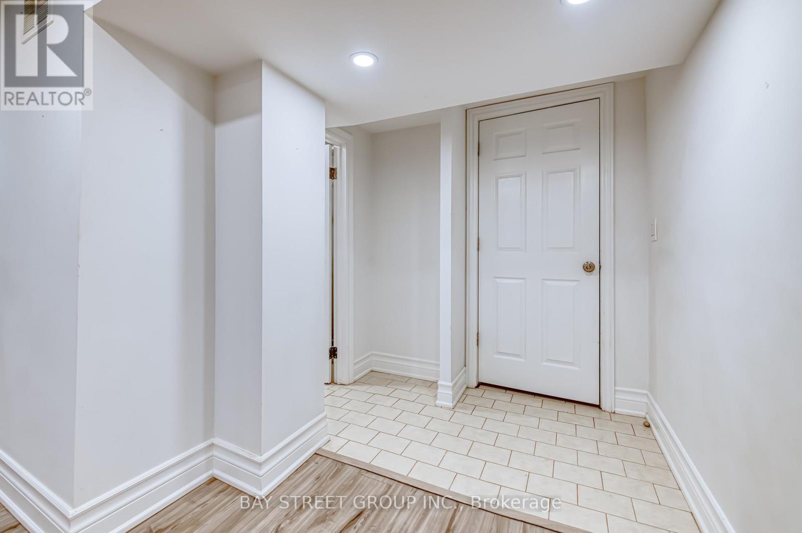 A white door is in a white room with white walls.