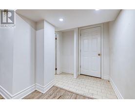 A white door is in a white room with white walls.