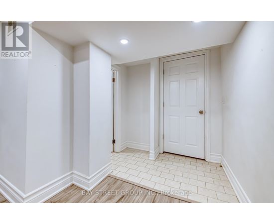 A white door is in a white room with white walls.