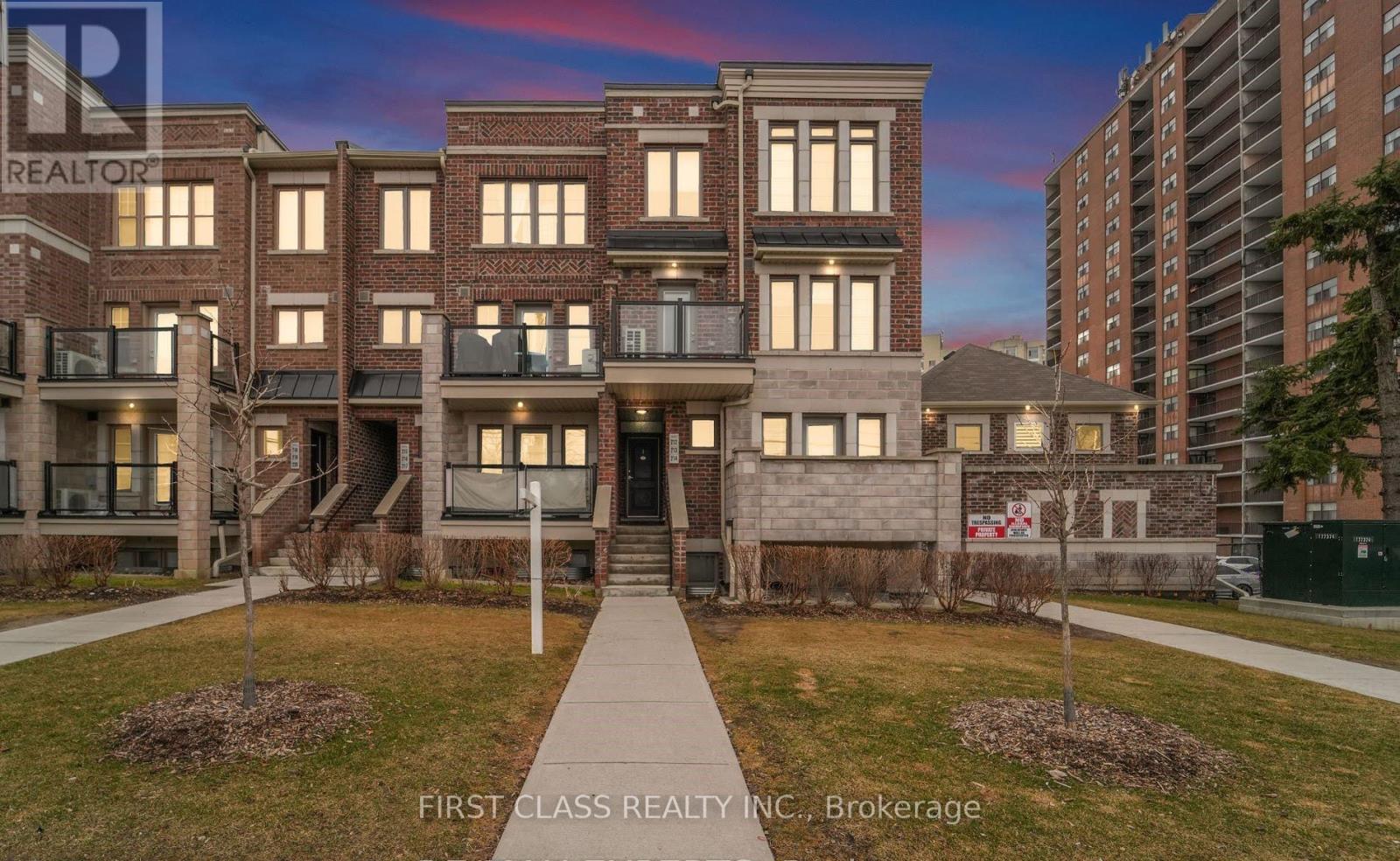 A building with the words "First Class Realty Inc., Brokerage" on the side.