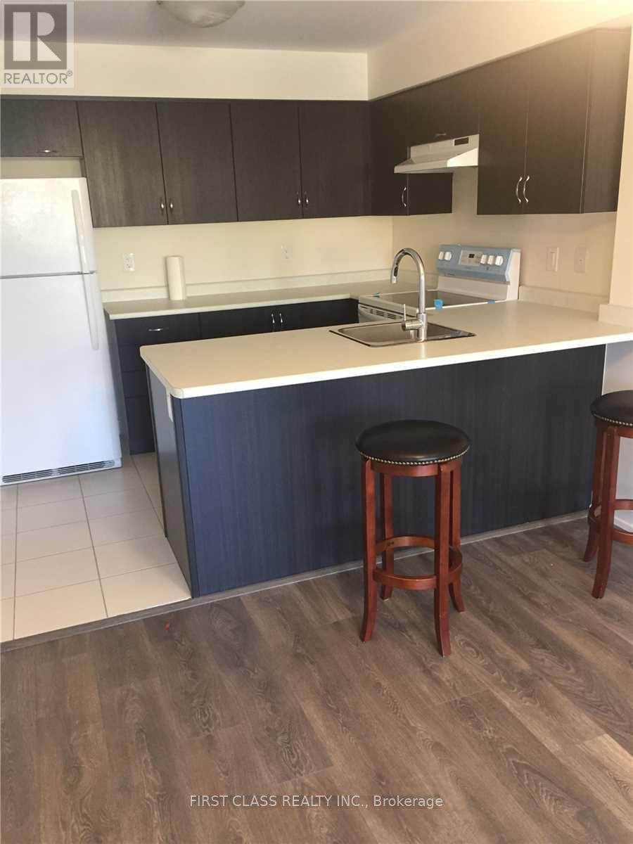 A kitchen with a white fridge and a white counter top.