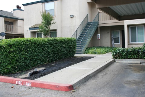 A fire lane is painted red in front of a building.