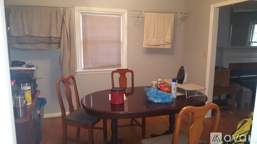 A dining room with a table and chairs.