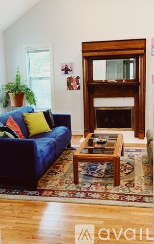 A living room with a blue couch and a wooden coffee table.