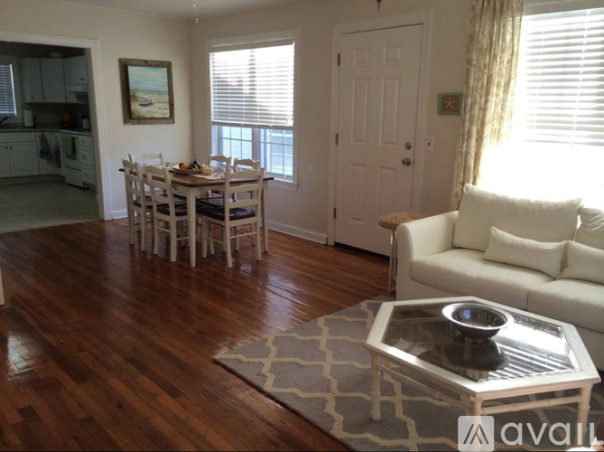 A living room with a dining table and chairs.