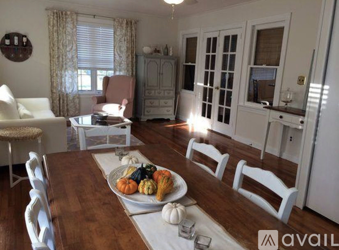 A dining room with a wooden table set for a meal.