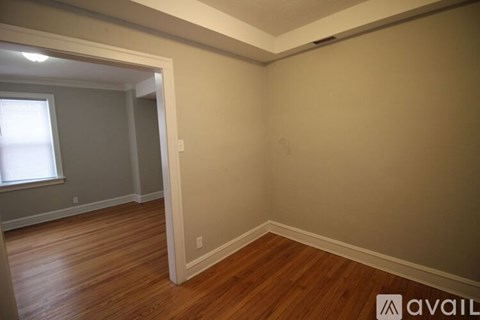A room with wooden floors and a window.